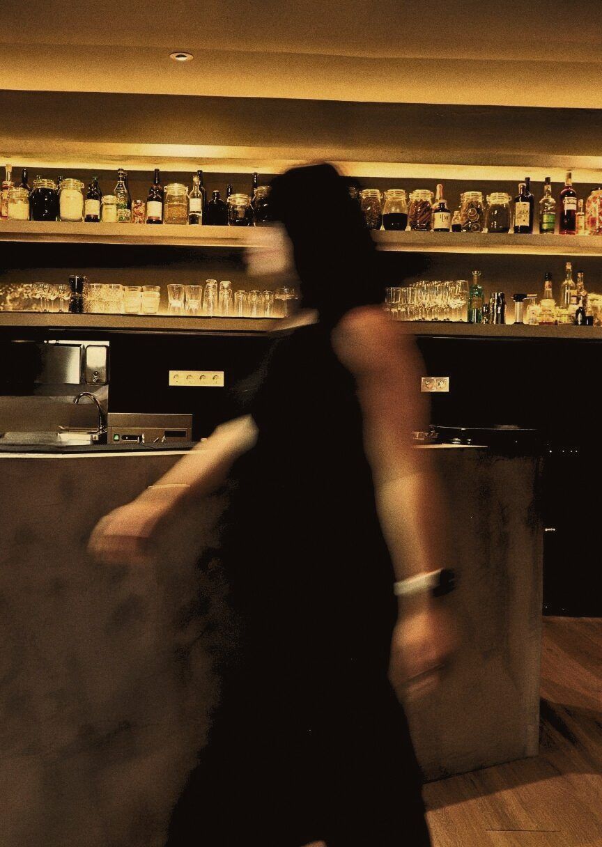 Stillroom's dining room in full service, with the bar and shelves in the background
